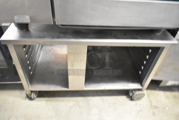 Rational SelfCooking Center commercial oven on stainless steel double pan rack stand with casters, slight wear visible.