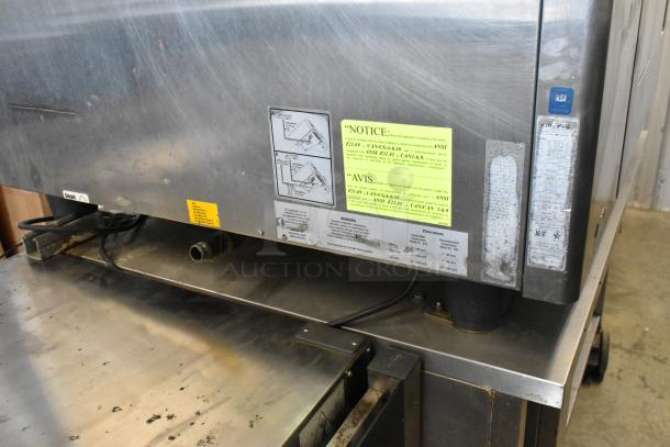 Rational SelfCooking Center stainless steel commercial combi oven with double pan rack, equipment stand, visible labels and markings.
