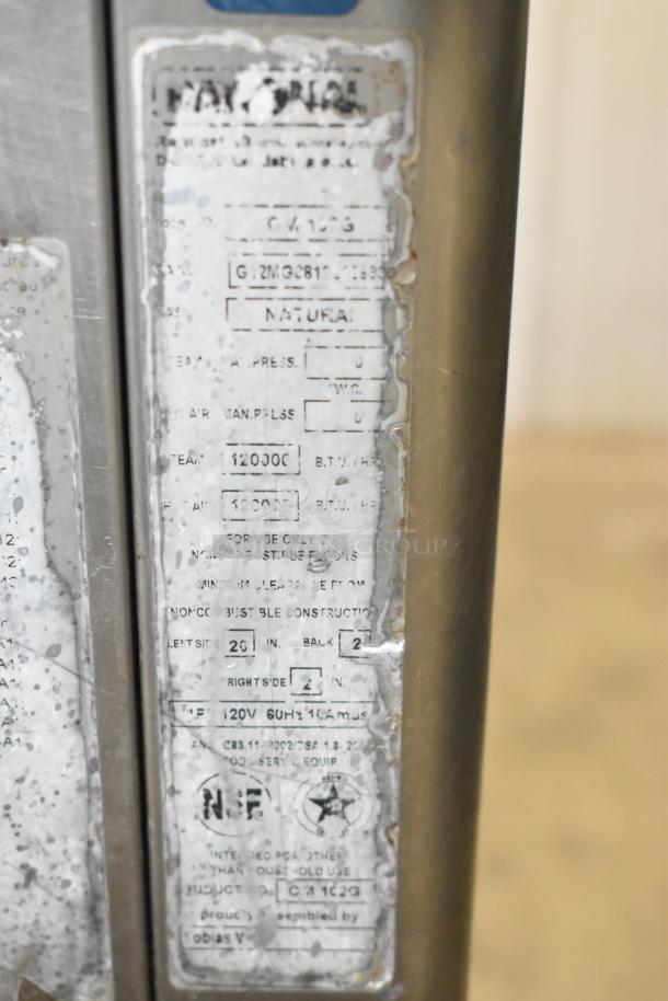 Rational SelfCooking Center stainless steel combi oven on double pan rack with commercial casters, worn condition label showing model details.