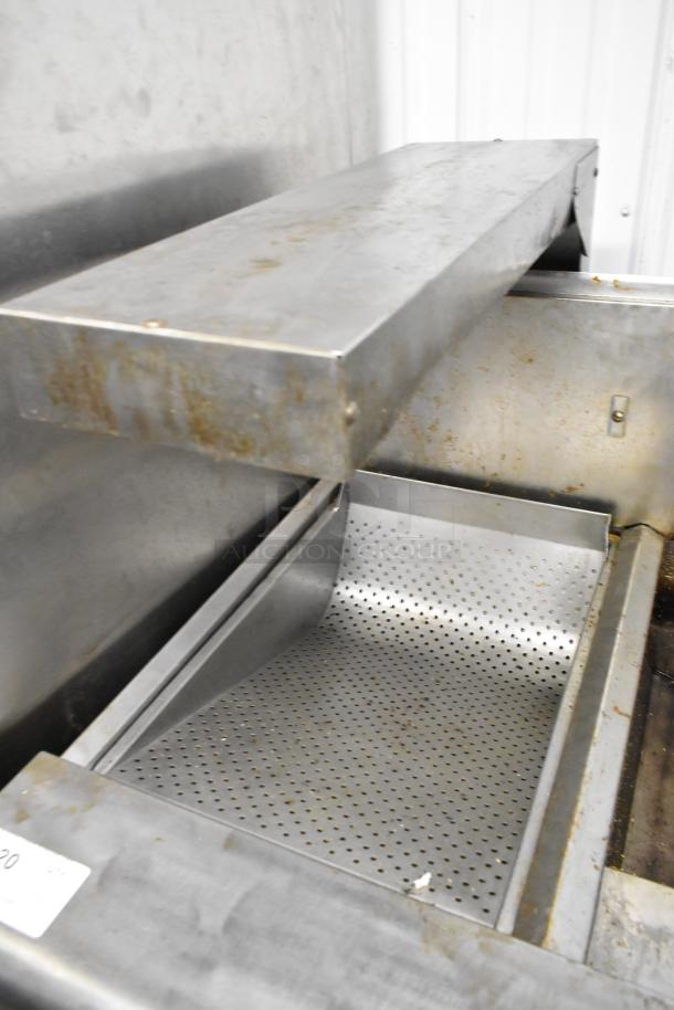Frymaster FMPH255CSC 2-bay deep fat fryer in stainless steel with filtration and dumping station, on commercial casters.