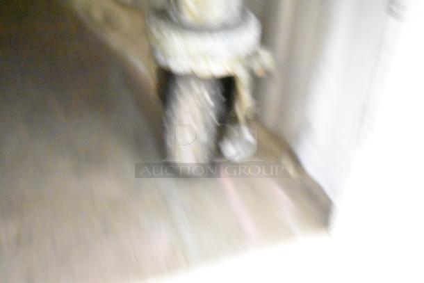 Blurry image of a Frymaster FMPH255CSC deep fryer on casters. Visible wheel detail, indicating mobility feature.