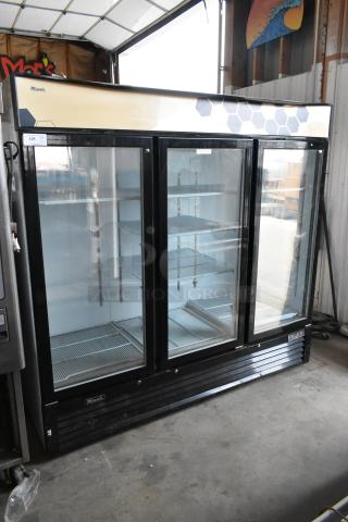2018 Migali C-72FM 3-door reach-in freezer with poly-coated racks, glass doors, black frame, 115/208-230 Volts, 1 Phase.