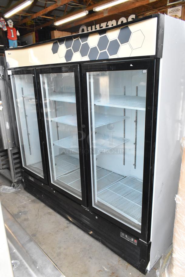 2018 Migali C-72FM 3-door freezer merchandiser with poly-coated racks, in good condition. Model details on top.