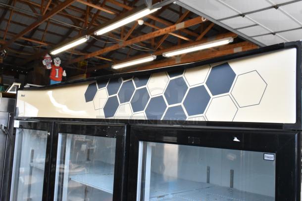 2018 Migali C-72FM 3-door commercial freezer with poly-coated racks, 115/208-230V, 1 phase, showing glass doors and hexagon design.