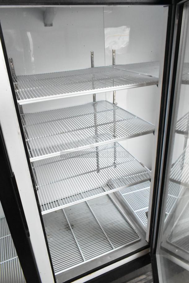 2018 Migali C-72FM 3-door freezer merchandiser with poly-coated racks. Excellent condition, 115/208-230V, 1 phase.