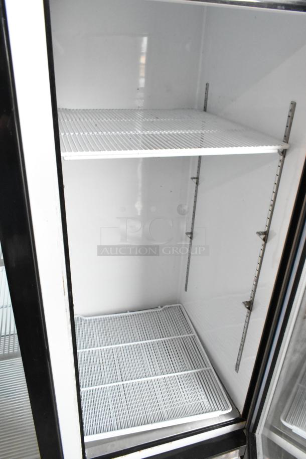 2018 Migali C-72FM 3-door reach-in freezer merchandiser with poly-coated racks. Clean interior, commercial use.