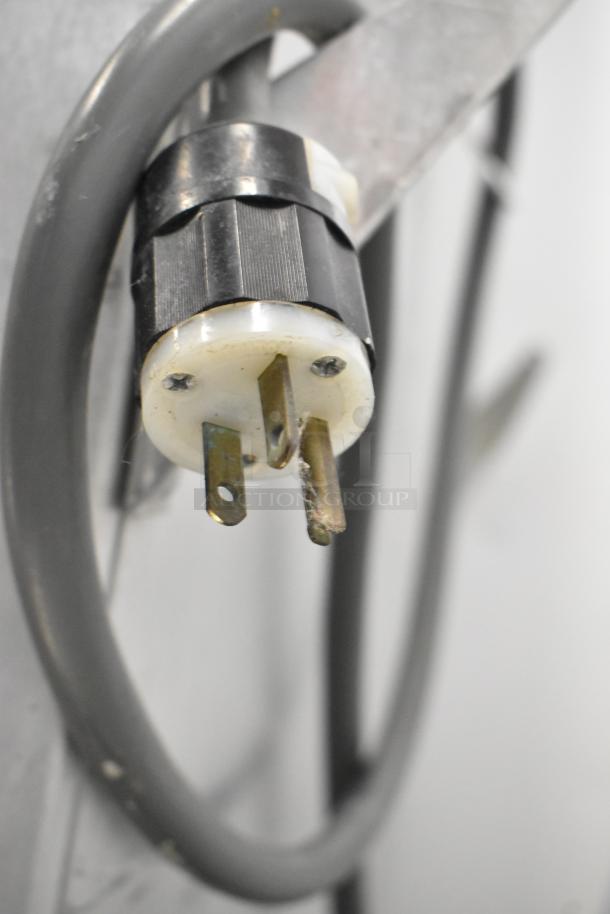 Power plug of Metro C199-M(1)N-B HM2000 heated holding cabinet, showing three-prong plug and attached power cable.