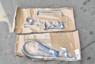 BRAND NEW SCRATCH AND DENT Waterloo Faucet with spray nozzle, chrome finish, complete set on cardboard packaging, minor blemishes.