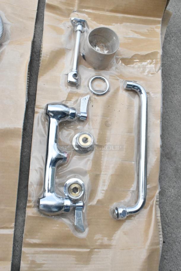 Brand new Waterloo faucet with spray nozzle attachment, chrome finish, minor scratches and dents visible, components included.