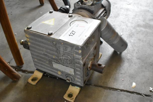 Industrial motor with metallic body and visible wear. Features a label indicating auction number 127 from PCA Auctions.