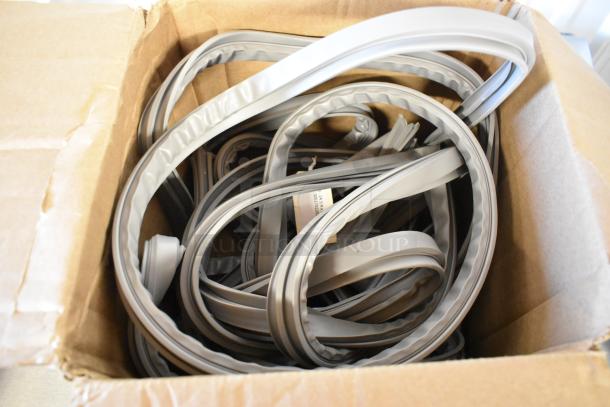 Brand new scratch and dent Delfield 1702201 equivalent door gasket, 24 3/4" x 60 3/4", shown coiled in box.