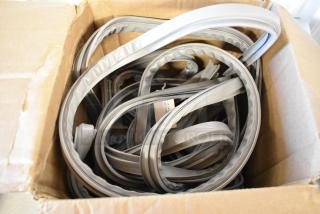 Brand new scratch and dent Delfield 1702201 equivalent door gasket, 24 3/4" x 60 3/4", shown coiled in box.