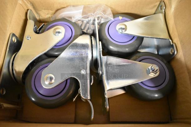 Lot of 4 brand new commercial casters in box; scratch and dent condition with purple wheels and metal brackets.