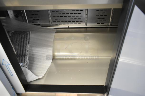 Brand new Avantco 447APST72 stainless steel prep table, scratch and dent condition, showing interior shelving details.