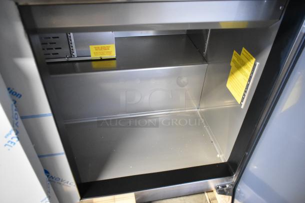 New Avantco 447APST72 stainless steel prep table interior, showing shelves. Scratch and dent model. Commercial quality.