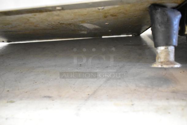QNC GF5 Stainless Steel Commercial Fryer base showing signs of use, leg detail, 208V, 1 phase, ventless, greaseless model.