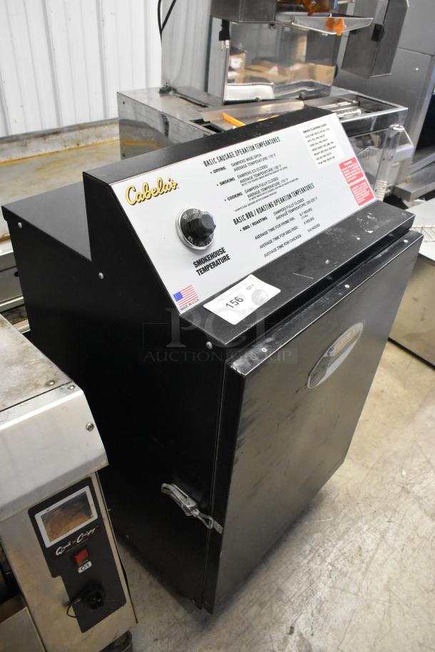 Pro Smoker N Roaster PK50PP electric smoker, metal, 120V, 1-phase. Cabela's branding, temperature dial visible.