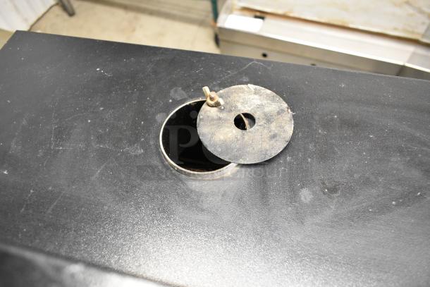 Pro Smoker N Roaster PK50PP commercial smoker, metal surface, visible smoke vent, lightly worn condition.