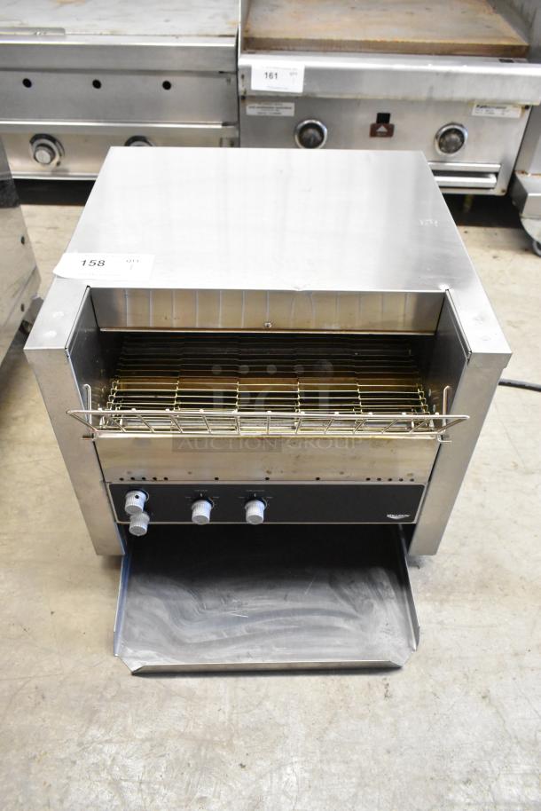 Vollrath JT3H Stainless Steel Conveyor Toaster Oven, 220V, 1 Phase, in good condition. Features control knobs and wire rack.