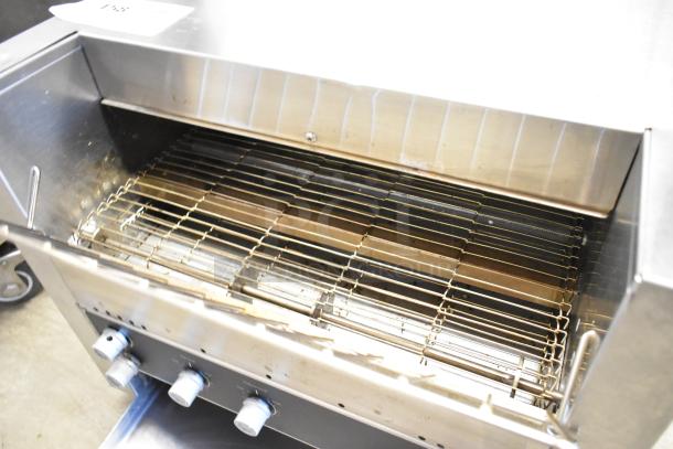 Vollrath JT3H stainless steel commercial conveyor toaster oven, 220V, 1 phase, showing heating elements and control knobs.