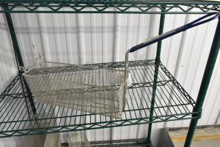 Brand new Pitco® P6072185 17 1/4" x 5 1/2" x 5 3/4" triple size fryer basket with front hook, on a shelf.