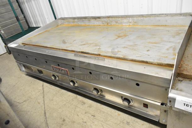 Vulcan stainless steel commercial countertop flat top griddle, used condition, features multiple control knobs and Vulcan badge.