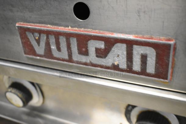 Vulcan stainless steel griddle with visible branding, featuring durable knobs, in used condition.