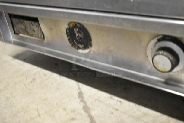 Vulcan stainless steel commercial countertop flat top griddle, showing front controls, in used condition.