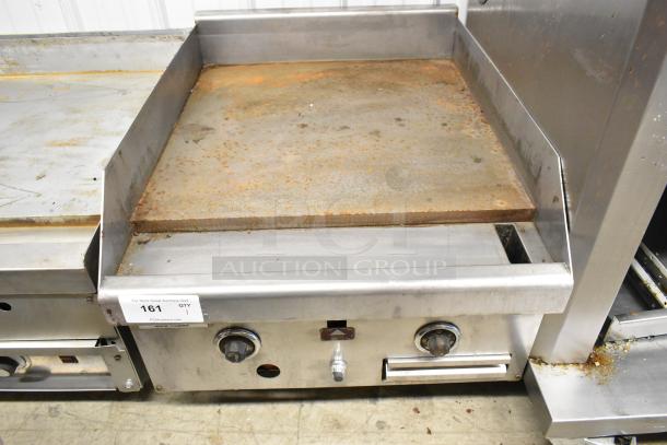 Stainless steel commercial countertop gas griddle with flat top, showing signs of wear. Knobs and label indicating auction lot number 161.