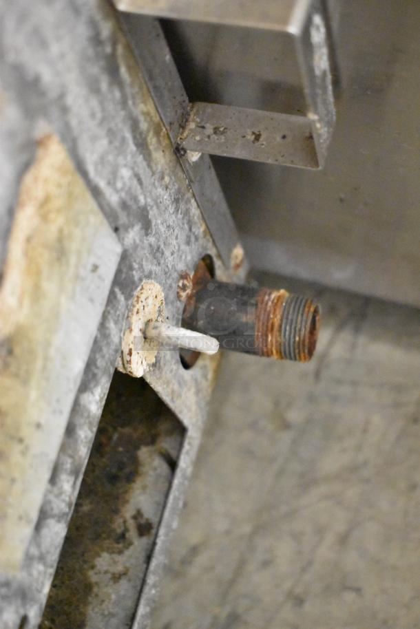 Rusty gas connector of stainless steel commercial countertop gas-powered flat top griddle. Signs of wear visible.