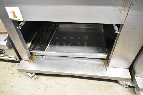 Fri-jado TDR7-P stainless steel commercial rotisserie oven on casters, electric, 208V, 3-phase, visible broken glass.