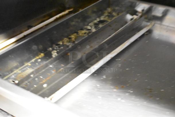 Fri-jado TDR7-P stainless steel rotisserie oven with visible interior wear and broken glass. Commercial casters, 208V, 3-phase.