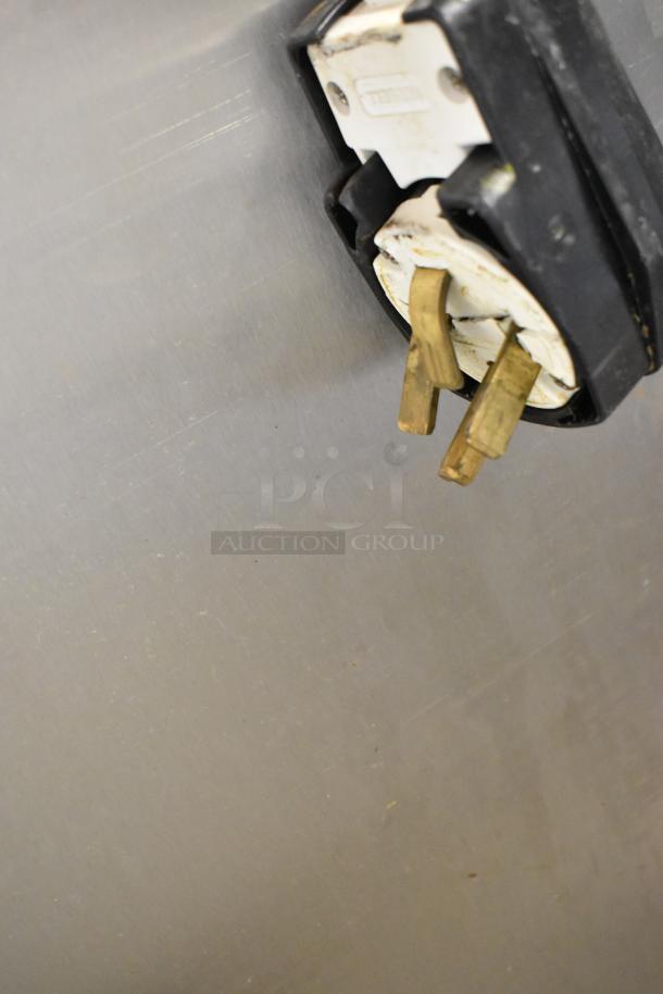 Stainless steel plug of Fri-jado TDR7-P rotisserie oven, showing wear. Electric powered, 208 volts, 3 phase.
