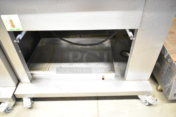 Fri-jado TDR7-P stainless steel commercial rotisserie oven, electric powered, on commercial casters, 208V, 3 phase.