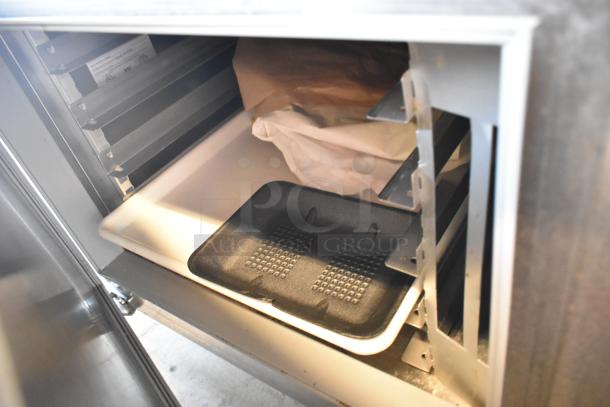 Traulsen TD078HT-ZSC01 stainless steel seafood display case interior, featuring shelves and a storage tray. 115V, 1 phase.