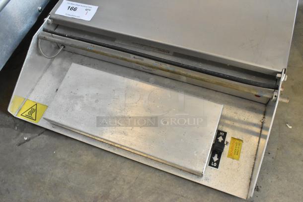 Metal countertop sealing station, 115 volts, 1 phase, in used condition with temperature control markings and warning labels.