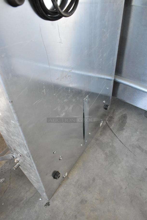 Metal countertop sealing station, 115 volts, 1 phase. Features a durable metallic construction. Some surface wear present.
