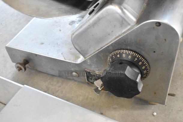 Globe stainless steel countertop meat slicer with blade sharpener, 115V, 1 Phase. Features adjustable slicing dial. Good condition.