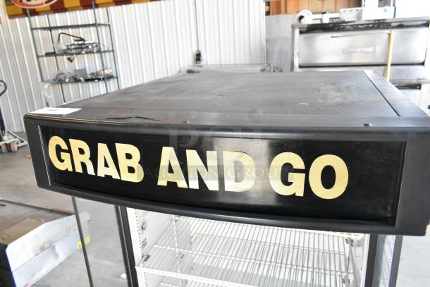 2017 True TAC-14GS-LD merchandiser, black, "Grab and Go" sign, 115V, 1 Phase, commercial, open shelves, metal construction.