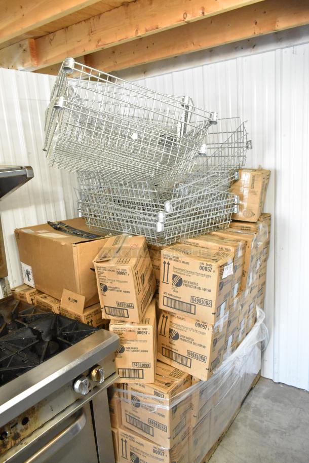 97 metal baskets and Diversified Chemical Tech Oven Shield boxes stacked in a warehouse, ready for auction.