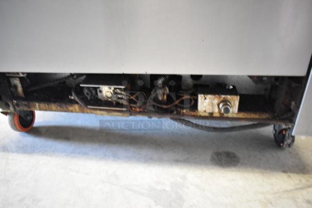 Southbend stainless steel commercial 6 burner gas range with oven, over shelf, backsplash, and casters. Visible wear.