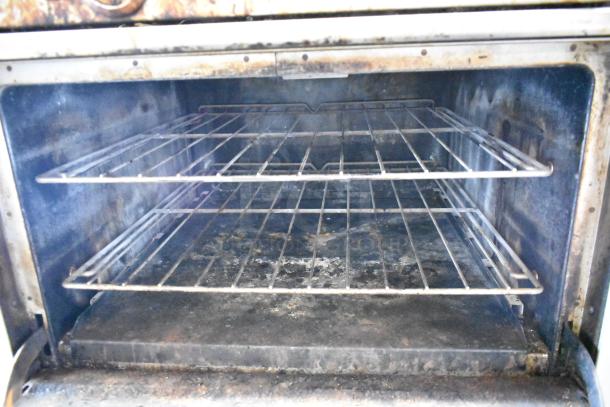 Southbend stainless steel commercial oven interior with two racks, showing signs of wear. Ideal for restaurant use.