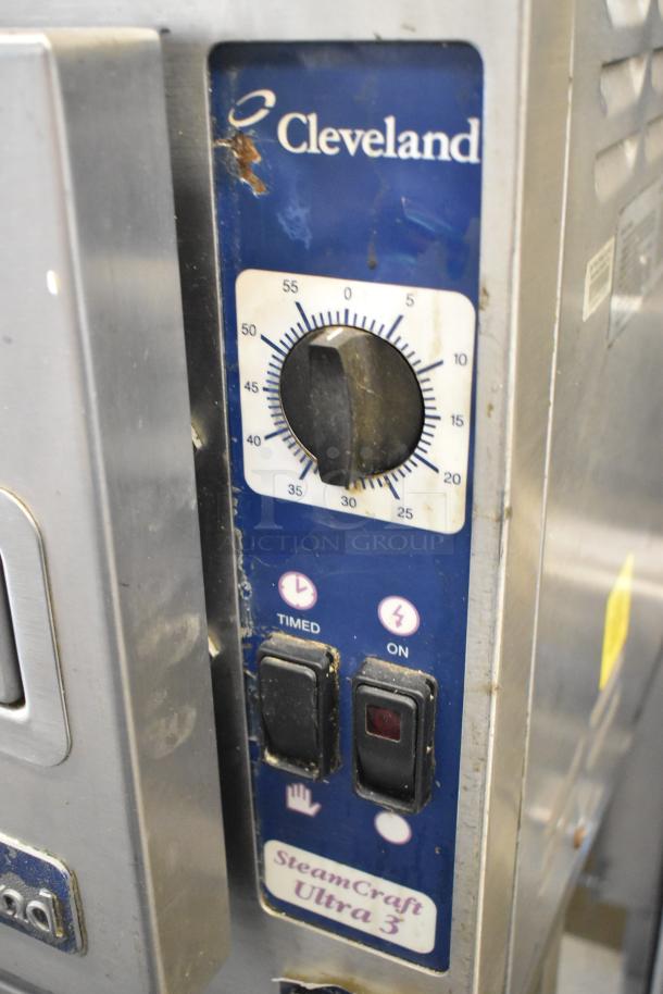 Cleveland 21CET8 SteamCraft Ultra 3 stainless steel steam cabinet control panel, showing timer and power switches.