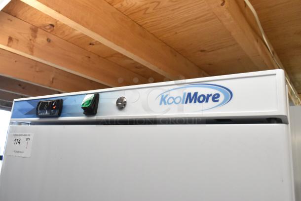 KoolMore KM-FMD12WH 12 Cu. ft. commercial reach-in freezer, white, manual defrost, badge and controls visible.