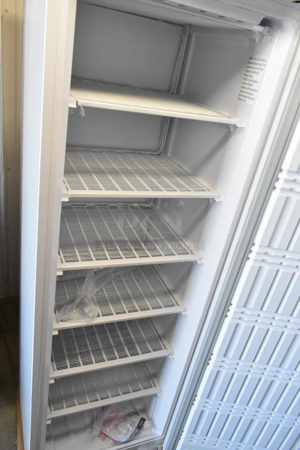 KoolMore KM-FMD12WH 12 Cu. ft. commercial reach-in freezer, white, manual defrost, 115V, clean interior with multiple shelves.