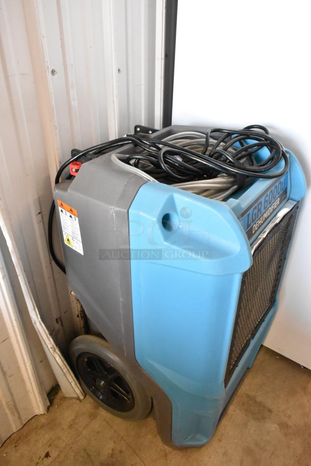 Drieaz LGR 6000Li dehumidifier, 115 volts, 1 phase, in good condition. Blue and gray with visible label and power cord.