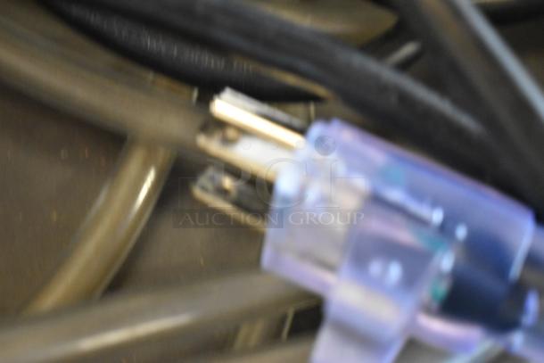 Blurry close-up image of a power cord with a plug, possibly from a Drieaz LGR 6000Li Dehumidifier.