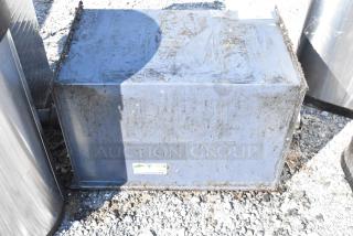 Metal commercial grease trap, used condition with visible wear and rust. Features affixed label indicating model details.