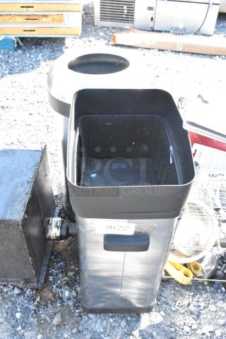 Two metal trash cans with lid openings, showing a modern design. Auction label "181" visible. Good condition.