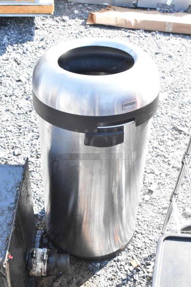 Stainless steel trash can with a black rubber rim and simplehuman label, outdoor setting, second can included in auction.